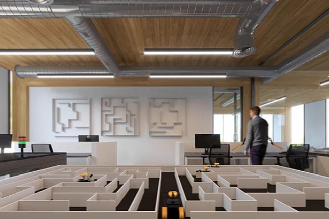 lab space with autonomous vehicles navigating a maze and a person in the background